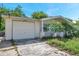 Charming single-story home with attached garage and mature tropical landscaping at 10125 Cherry Creek Ln, Port Richey, FL 34668