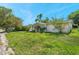 Charming single-story home showcasing a green front lawn and curb appeal at 10125 Cherry Creek Ln, Port Richey, FL 34668