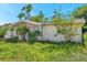 Charming single-story home featuring mature landscaping and an attached garage at 10125 Cherry Creek Ln, Port Richey, FL 34668