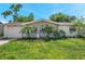 Charming single-story home with attached garage and well-maintained landscaping at 10125 Cherry Creek Ln, Port Richey, FL 34668