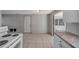 Kitchen features tile flooring, an exterior door, and a view of the interior at 10125 Cherry Creek Ln, Port Richey, FL 34668