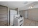 Kitchen with white appliances, tile floors, and convenient shelving at 10125 Cherry Creek Ln, Port Richey, FL 34668