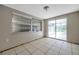 Living room with tile floors and a sliding door to a Florida room, providing natural light at 10125 Cherry Creek Ln, Port Richey, FL 34668