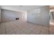 Open living area showcasing tile floors and access to other rooms at 10125 Cherry Creek Ln, Port Richey, FL 34668