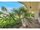 Cozy porch showcasing lush tropical plants, creating a serene outdoor space at 10125 Cherry Creek Ln, Port Richey, FL 34668