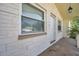 Relaxing porch area, natural light through window and palm tree view at 10125 Cherry Creek Ln, Port Richey, FL 34668