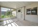Enclosed sunroom featuring multiple windows allowing ample light and views of the backyard at 10125 Cherry Creek Ln, Port Richey, FL 34668