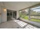 Bright sunroom with sliding glass door and multiple windows offering scenic outdoor views at 10125 Cherry Creek Ln, Port Richey, FL 34668