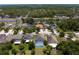 Wide aerial view of the community, surrounded by lush greenery and a nearby highway and lake at 10216 Summer Azure Dr, Riverview, FL 33578