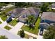 Aerial view of the house showing two-car garage, palm trees in the front yard, and well-maintained landscaping at 10216 Summer Azure Dr, Riverview, FL 33578