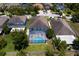 Aerial view of a fenced backyard featuring a screened-in pool, lush green lawn, and mature trees at 10216 Summer Azure Dr, Riverview, FL 33578