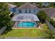 Aerial view of a home featuring a screened-in pool, deck, and grassy backyard at 10216 Summer Azure Dr, Riverview, FL 33578