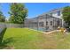 Grassy backyard with screened-in pool, brick paver deck, and outdoor furniture at 10216 Summer Azure Dr, Riverview, FL 33578