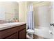 Well-lit bathroom featuring a shower-tub combination, tiled walls, and modern fixtures at 10216 Summer Azure Dr, Riverview, FL 33578
