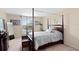 Primary bedroom featuring a canopy bed, carpeted floors and ample natural light at 10216 Summer Azure Dr, Riverview, FL 33578