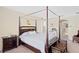 Bedroom with canopy bed, neutral walls, carpet and view to the bathroom at 10216 Summer Azure Dr, Riverview, FL 33578