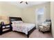 Cozy bedroom featuring a comfortable bed, a patterned armchair, and natural light at 10216 Summer Azure Dr, Riverview, FL 33578