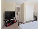 Bedroom with neutral walls, carpet, tv and stand, closet, and view to hall at 10216 Summer Azure Dr, Riverview, FL 33578