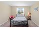 Bedroom with natural light, a wrought iron bed frame, and warm neutral walls at 10216 Summer Azure Dr, Riverview, FL 33578