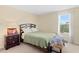 Cozy bedroom with a soft bed, side table, window view and a fluffy elephant toy at 10216 Summer Azure Dr, Riverview, FL 33578