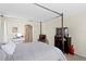 This bright bedroom features a four poster bed, TV and a makeup vanity at 10216 Summer Azure Dr, Riverview, FL 33578
