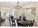 Bright dining room features a modern chandelier and flows into the living room and stairway at 10216 Summer Azure Dr, Riverview, FL 33578