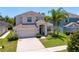Beautiful two-story home boasts lush greenery, mature trees, and a well-manicured lawn at 10216 Summer Azure Dr, Riverview, FL 33578