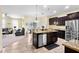Modern kitchen flows into the living area with stainless steel appliances, granite countertops, and ample cabinet space at 10216 Summer Azure Dr, Riverview, FL 33578