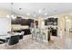 Open-concept kitchen featuring dark cabinets, granite countertops, stainless steel appliances, and a breakfast bar at 10216 Summer Azure Dr, Riverview, FL 33578