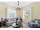 Cozy living room with natural light, neutral walls, carpet, and comfortable seating at 10216 Summer Azure Dr, Riverview, FL 33578