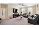 Spacious living room filled with natural light, dark furniture, and carpet flooring throughout at 10216 Summer Azure Dr, Riverview, FL 33578