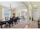Open-concept living and dining areas featuring tile flooring, neutral paint, and archways at 10216 Summer Azure Dr, Riverview, FL 33578