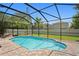 Screened-in pool with brick paver decking and view to grass backyard and home at 10216 Summer Azure Dr, Riverview, FL 33578