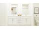Elegant bathroom with double vanity, quartz countertops, and modern fixtures at 10334 Gentle Rain Dr, Land O Lakes, FL 34638
