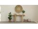 Minimalist entryway featuring console table, plants, and wall decor creates an inviting ambiance at 10334 Gentle Rain Dr, Land O Lakes, FL 34638