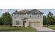 Charming two-story home with attached two car garage, green lawn and mature trees at 10334 Gentle Rain Dr, Land O Lakes, FL 34638