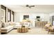 Bright living room featuring an open floor plan, neutral decor, and modern furnishings at 10334 Gentle Rain Dr, Land O Lakes, FL 34638