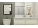 Cozy bathroom features a framed painting, marble counter top with white cabinets, and shower behind a curtain at 10857 Rustic Eve Ct, Land O Lakes, FL 34638