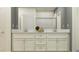 Bathroom with double sink vanity, stylish mirrors, white cabinets, and a walk-in shower at 10857 Rustic Eve Ct, Land O Lakes, FL 34638