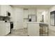 Well-equipped kitchen with white cabinetry, stainless steel appliances, and a convenient island with bar seating at 10857 Rustic Eve Ct, Land O Lakes, FL 34638