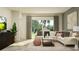 Bright living room features a sectional sofa, area rug, and expansive windows with views of the outdoor greenery at 10857 Rustic Eve Ct, Land O Lakes, FL 34638