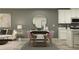 Open-concept living space with a dining table, comfortable seating, and a modern color palette at 10857 Rustic Eve Ct, Land O Lakes, FL 34638