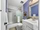 Cozy bathroom with tiled walls, shower with glass door, and single sink vanity at 1125 83Rd N Ave # D, St Petersburg, FL 33702