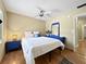 Stylish bedroom featuring wood floors, ceiling fan, and tasteful decor creating a serene atmosphere at 1125 83Rd N Ave # D, St Petersburg, FL 33702