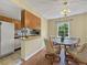 Dining area adjacent to kitchen; features modern light fixture and view to the backyard at 1125 83Rd N Ave # D, St Petersburg, FL 33702