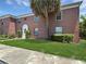 Charming red brick building with well-maintained lawn and landscape, creating a welcoming curb appeal at 1125 83Rd N Ave # D, St Petersburg, FL 33702