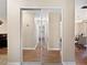 Hallway with mirrored closet doors leading to various rooms with wood flooring at 1125 83Rd N Ave # D, St Petersburg, FL 33702