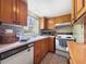Traditional kitchen featuring wood cabinets, tile backsplash, and updated appliances at 1125 83Rd N Ave # D, St Petersburg, FL 33702