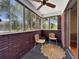 Enclosed sun room featuring brick walls, neutral carpeting, and floor-to-ceiling windows at 1125 83Rd N Ave # D, St Petersburg, FL 33702