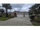 Charming home featuring a spacious three-car garage, lush landscaping, and a well-maintained lawn at 11341 Durham St, Parrish, FL 34219